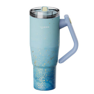 Blue gradient insulated travel mug with gold speckle pattern and a light blue handle, viewed from the side with a clear lid on top.