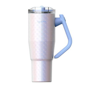 Pearl pink metal travel mug with light blue handle and transparent lid.