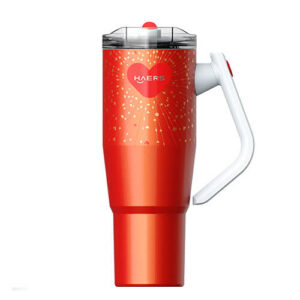 Red travel mug with a clear lid and white handle, featuring a heart logo and spark-like designs on the red body.