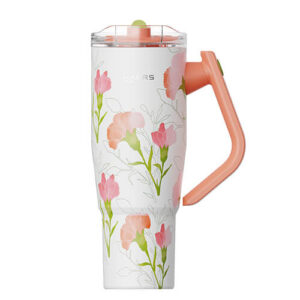 White insulated tumbler with a floral pattern in pink and peach, and a peach 'L' handle with a matching lid.