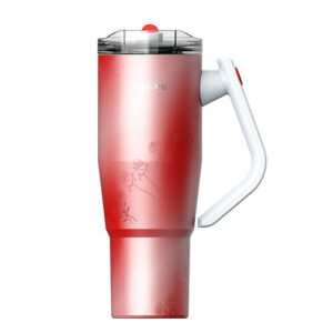 Red stainless steel travel mug with a floral pattern and white built-in handle, lid closed on top side.