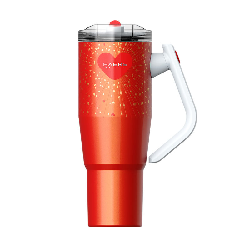 red gradient travel mug with a white handle and clear lid, featuring a heart logo and gold fireworks pattern.