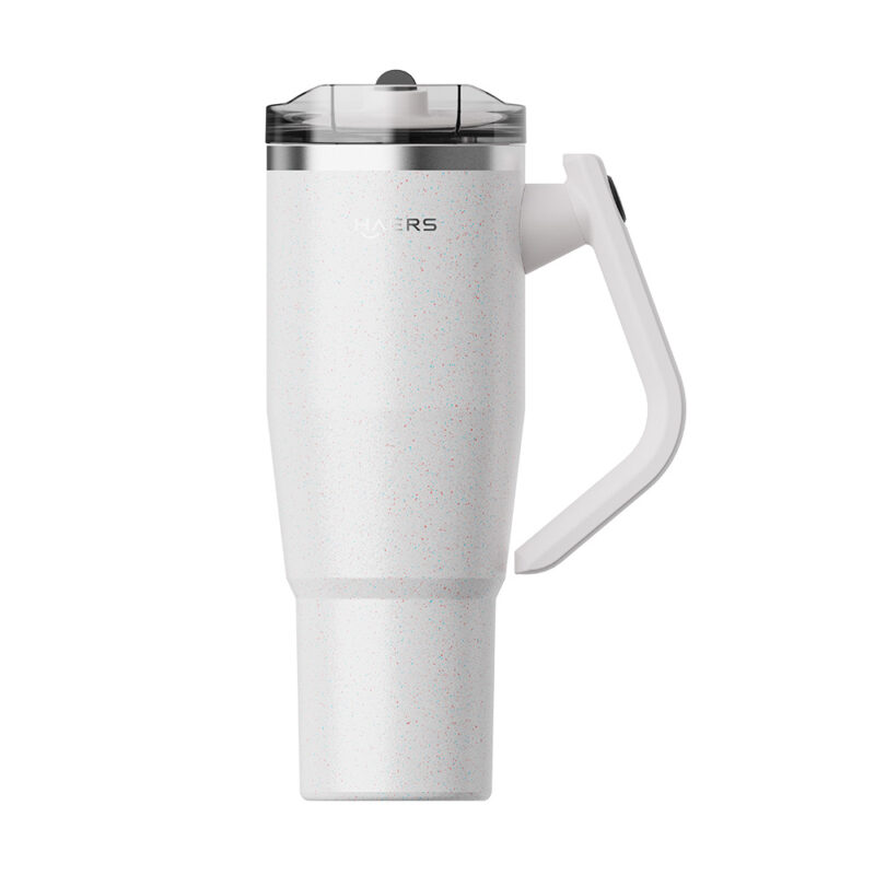 white speckled travel mug with a clear lid and curved white handle orients for to-go use.