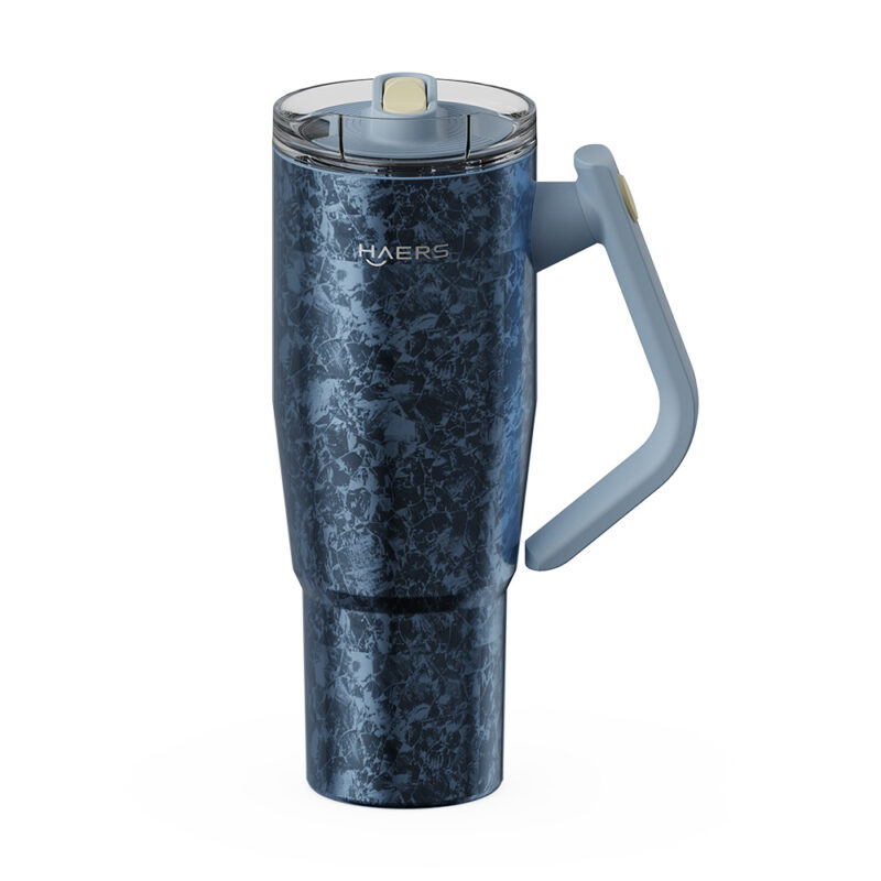 blue patterned insulated travel mug with a light blue handle and clear lid, branded haers, standing upright on a white background.