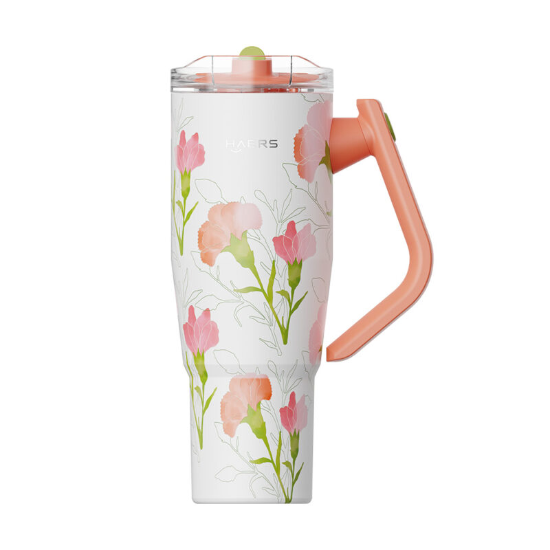 white insulated floral travel mug with a peach handle and matching peach lid detail on top.