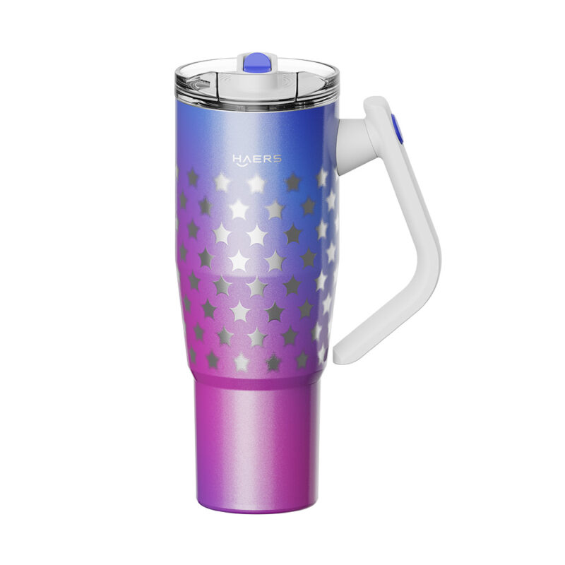 a gradient blue-to-pink travel mug with silver stars, white handle, and clear lid.