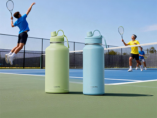 two tennis players in action on a blue court, with lime and light blue insulated water bottles in the foreground.
